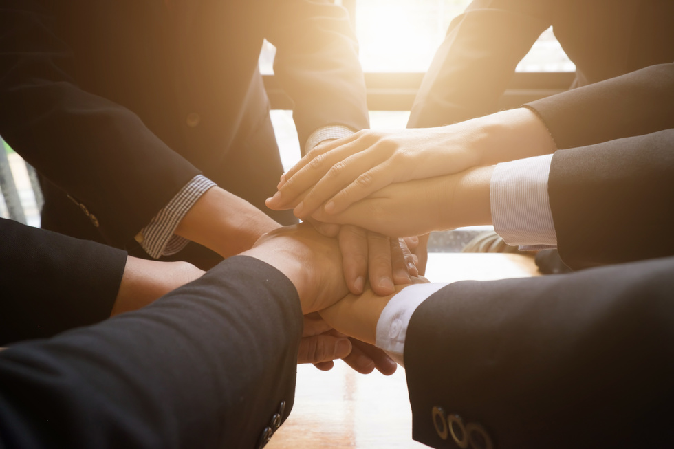Group of Business People Joining Hands Together